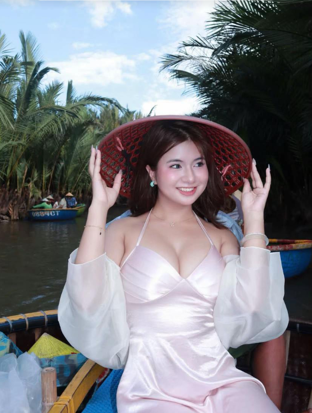 Góc chụp nhân vật trên thuyền với mặt nước và cây xanh làm nền