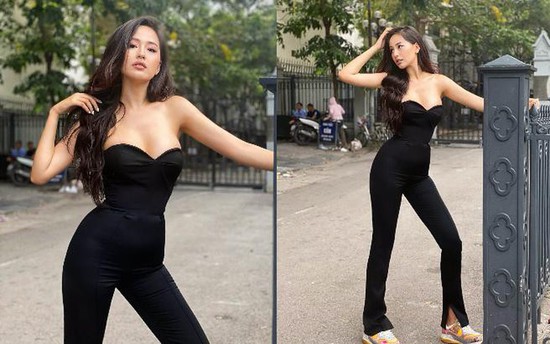 Mai Phương Thúy tạo dáng bên hàng rào trong khung cảnh giản dị