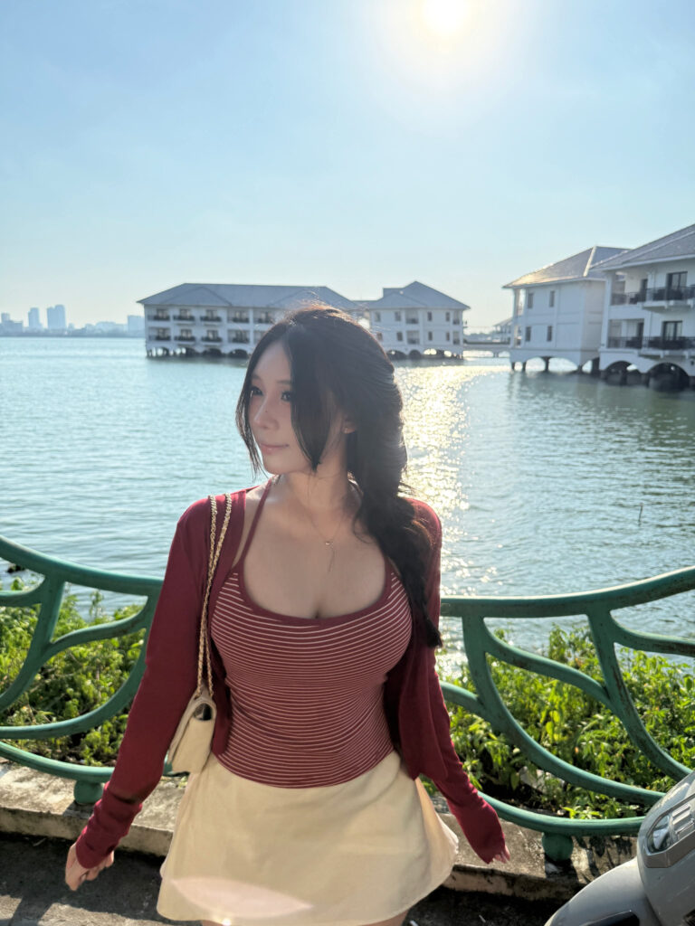 Cô gái quay lưng về phía máy ảnh bên lan can màu xanh